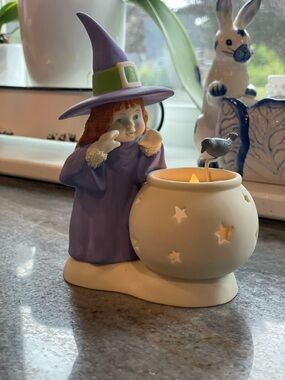 Retired Department 56 snow baby. “Stirring up a little magic” tea light candle.